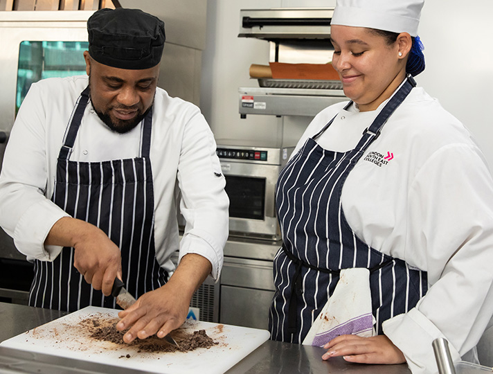 Student preparing meal in the industry kitchen