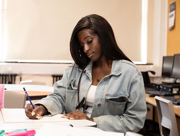 Student working at a desk in classroom