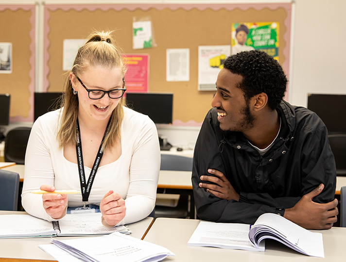 AAT students working and helping each other in the classroom