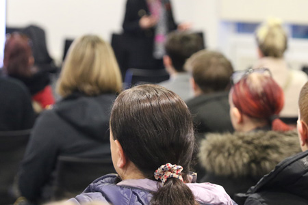 Students listening to talk held by employer